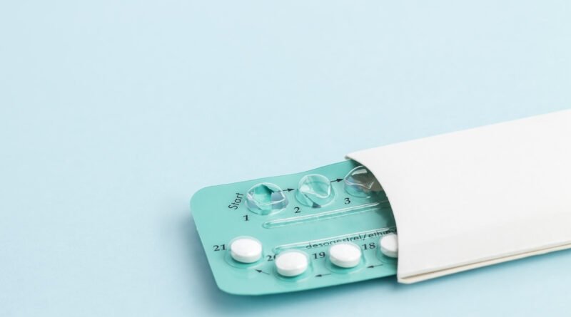 Contraception pills on blue background. Birth control
